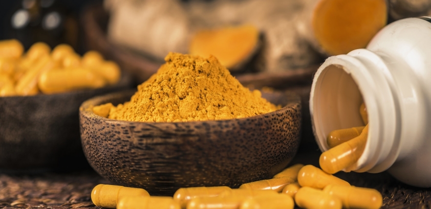 Curcumin Herbal Supplement Capsules and Turmeric Powder