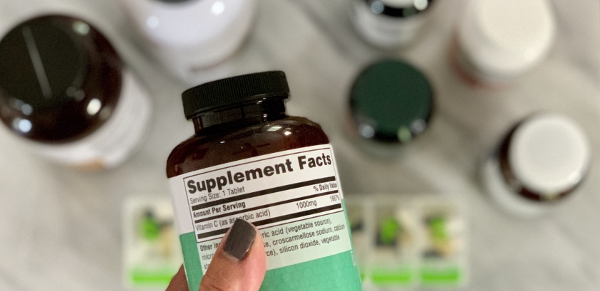 Reading the label on supplement pill bottle