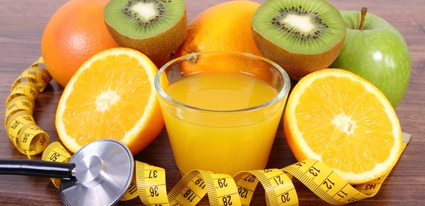 Stethoscope, fresh fruits, juice and centimeter, healthy lifestyles and nutrition